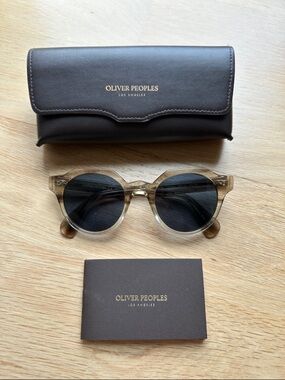 Oliver Peoples Transparent Brown Round Sunglasses with Dark Lenses
